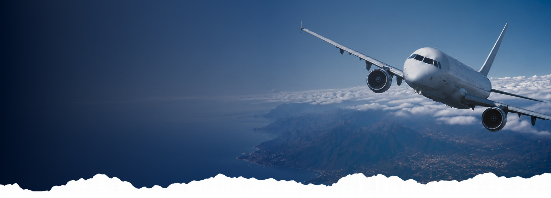 Passenger aircraft flying above a sea of clouds at sunrise
